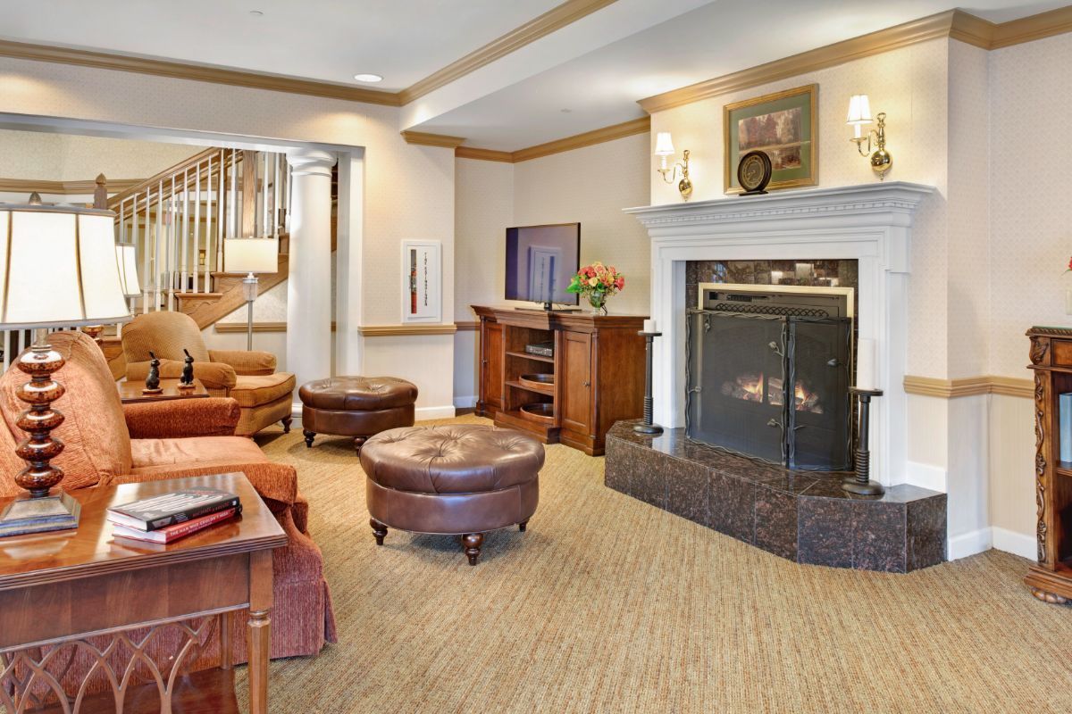 A cozy living room with a fireplace and comfortable seating.