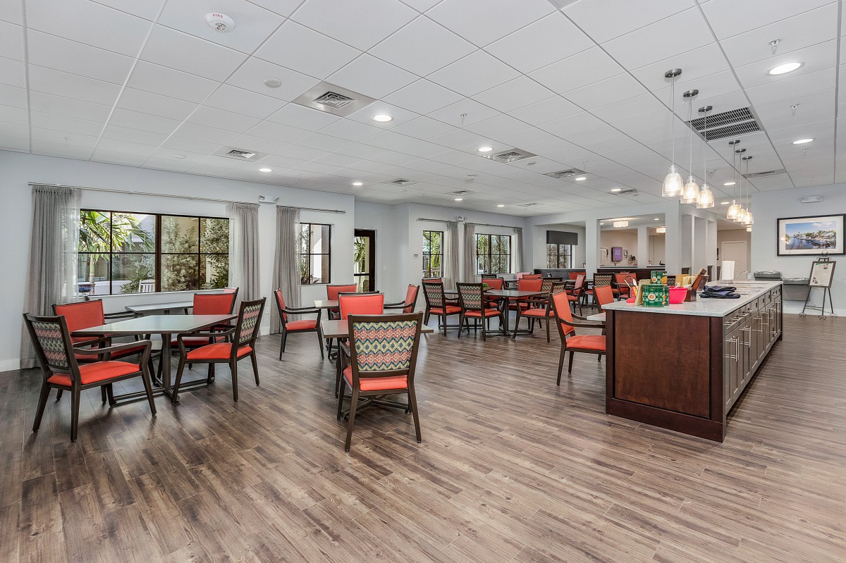 A spacious dining area with modern furnishings and ample natural lighting.