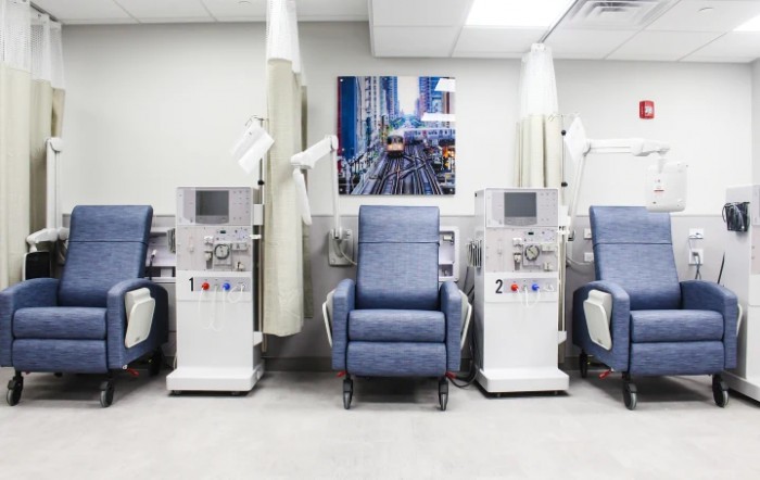 A hospital room equipped with dialysis machines and reclining chairs for patient treatment.