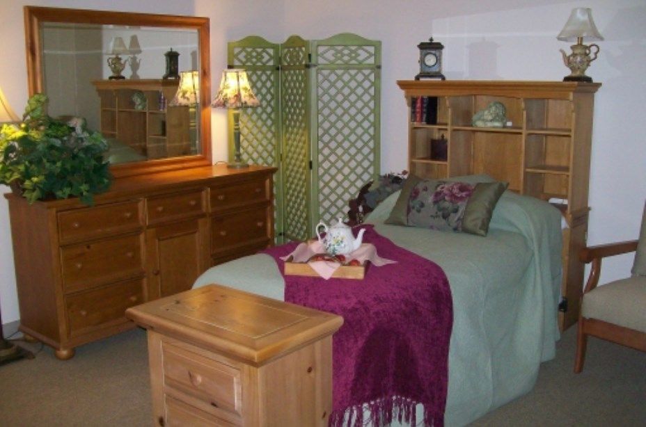 A cozy bedroom with wooden furniture and decorative accents.