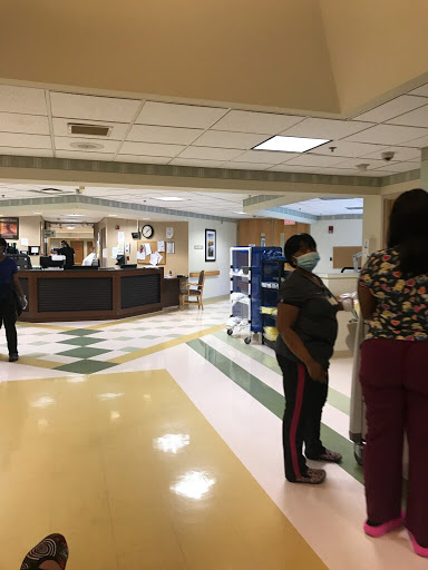 A busy hospital reception area with medical staff attending to patients.
