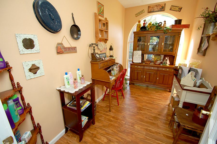 A cozy kitchen with vintage decor and wooden furniture.