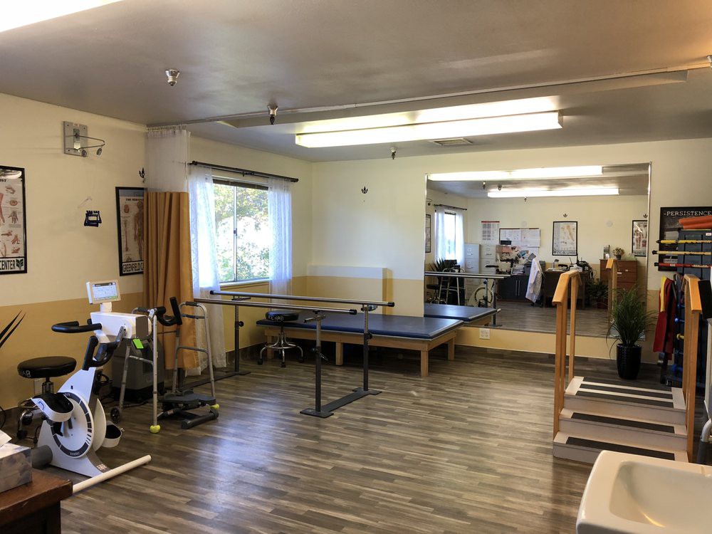 A physical therapy room equipped with exercise equipment and rehabilitation facilities.