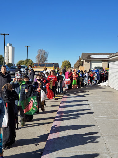 A long line of people waiting outside for a community event during the holiday season.