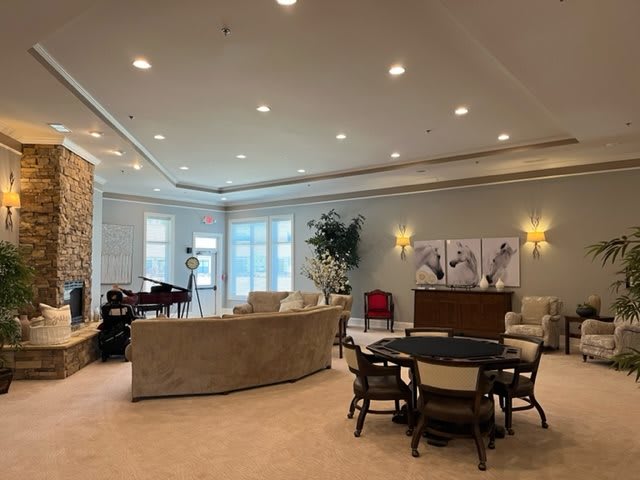 A spacious and luxurious living room featuring a modern interior design with comfortable seating and a dining area.