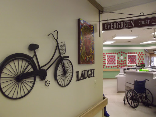 A cozy lounge area decorated with bicycle wall art and signs guiding visitors.