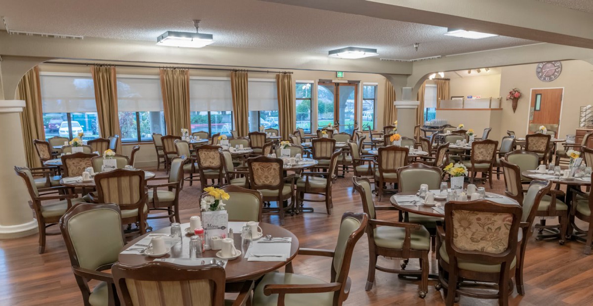 An elegant dining area with neatly arranged tables and chairs, awaiting guests.