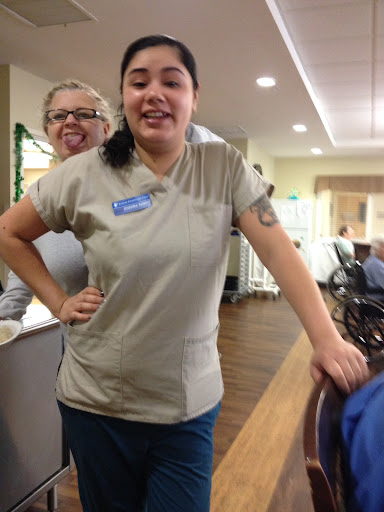 A cheerful moment captured in a healthcare setting, featuring staff members enjoying their time.