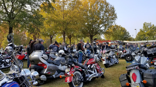A vibrant motorcycle rally surrounded by colorful autumn foliage.