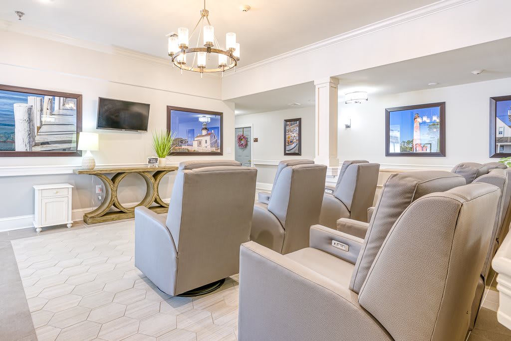 A modern waiting room with comfortable seating and a television.
