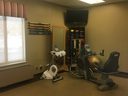 A well-equipped indoor gym area featuring exercise machines and fitness accessories.
