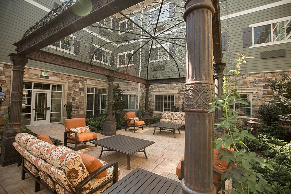 A beautifully designed courtyard with comfortable outdoor seating and a covered area.
