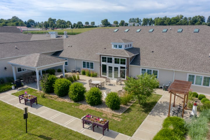 Aerial view of a modern building with a landscaped patio and outdoor seating.