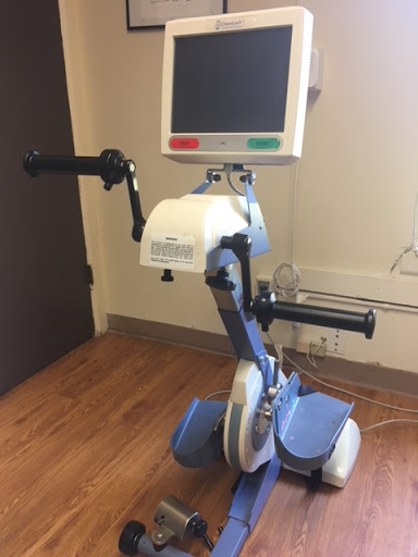 A rehabilitation exercise bike designed for physical therapy, featuring hand grips and a digital display.