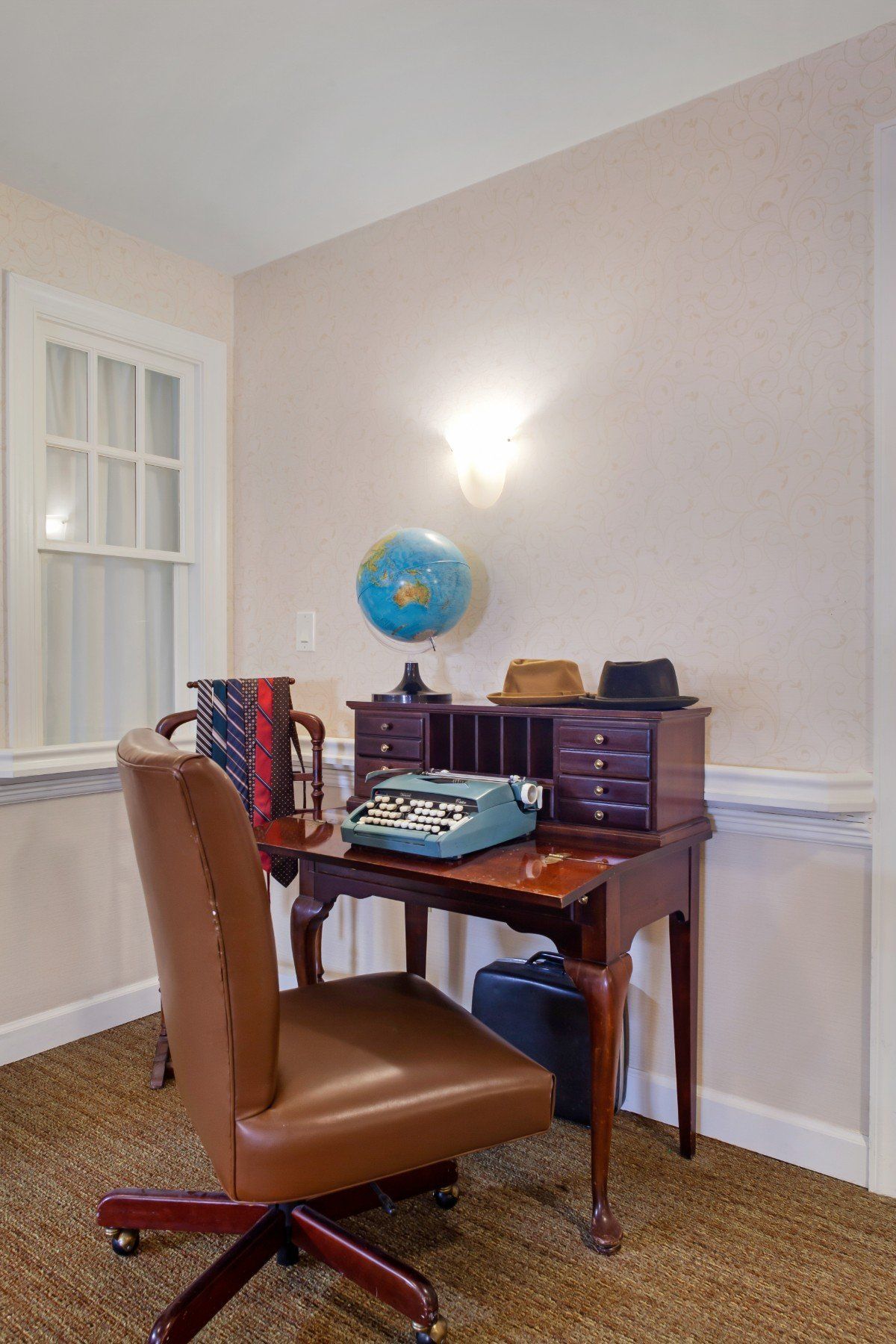 Vintage office setup with a typewriter and globe.