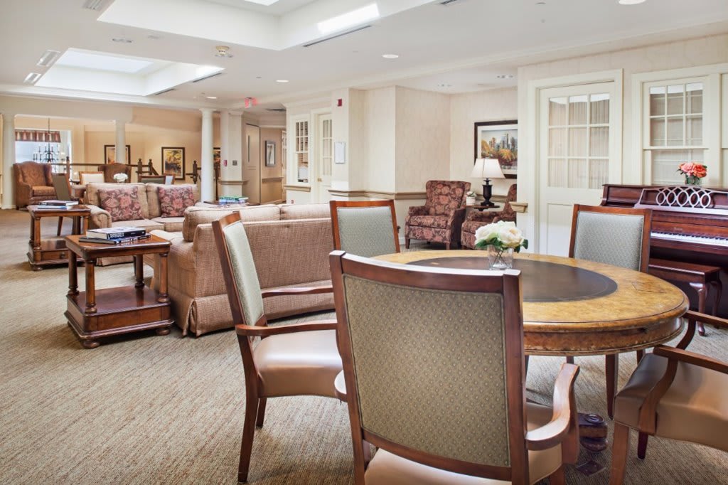 A bright and welcoming lounge area with comfortable seating and tables.