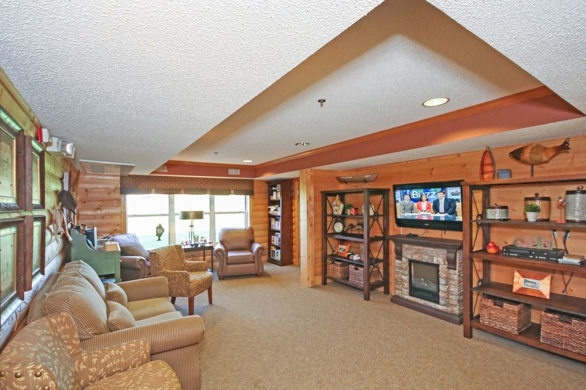 A cozy living room featuring a television, fireplace, and comfortable seating.
