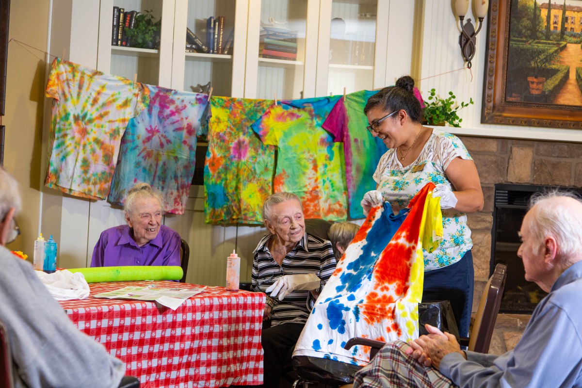 A group of seniors engage in a colorful tie-dye crafting session.
