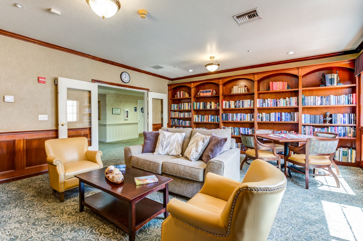 Cozy living room with bookshelves and comfortable seating.