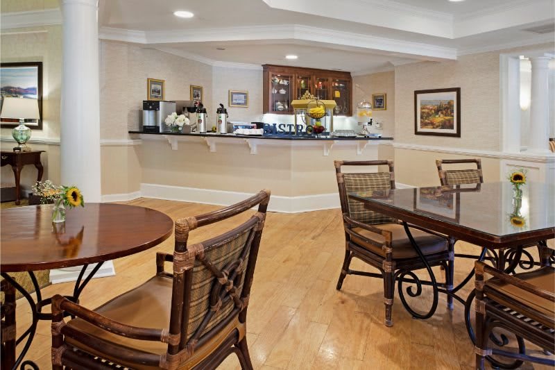 Cozy cafe interior with a coffee station and wooden furniture.