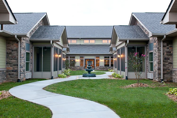 A modern courtyard with a central pathway and landscaped gardens.
