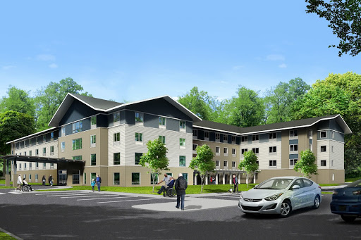 A modern residential building surrounded by greenery, showcasing contemporary architecture.