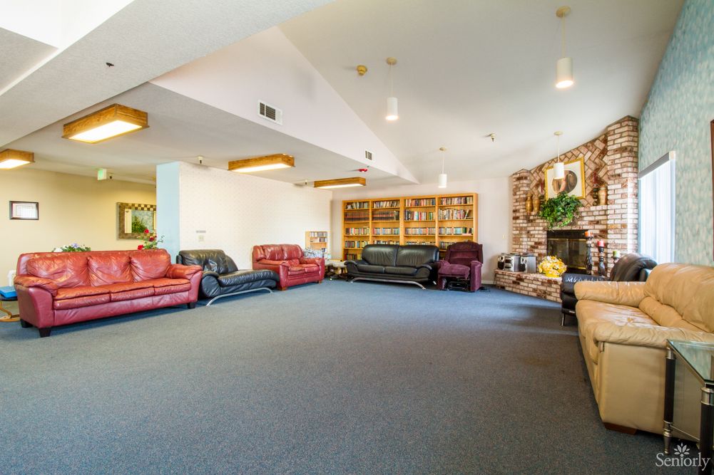 A spacious living room with multiple sofas and decorative elements.