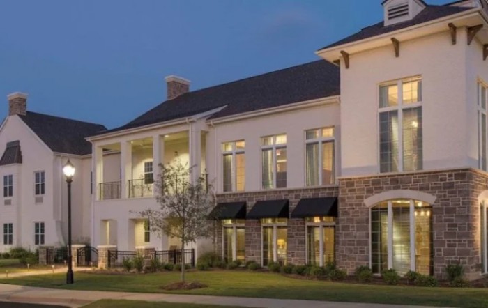 A beautifully illuminated residential building in the evening.