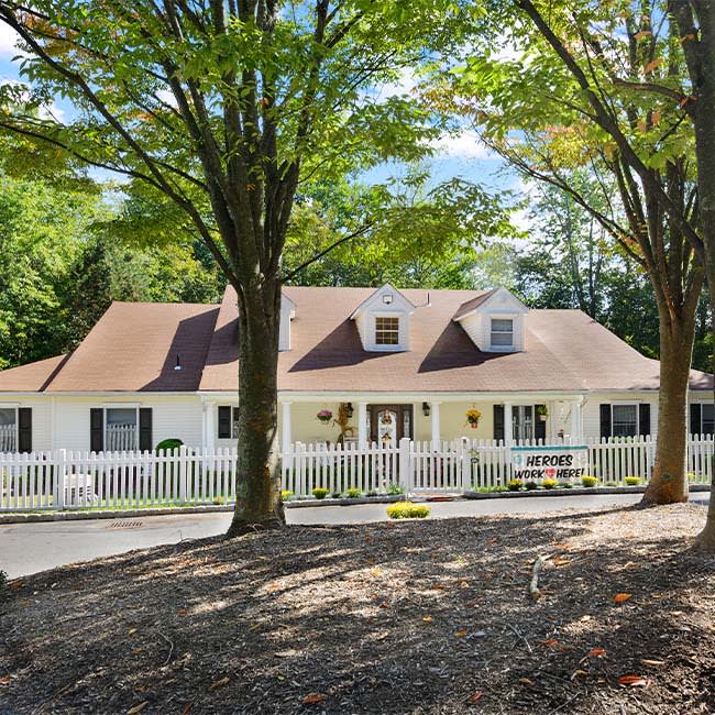 A charming residential house surrounded by trees.