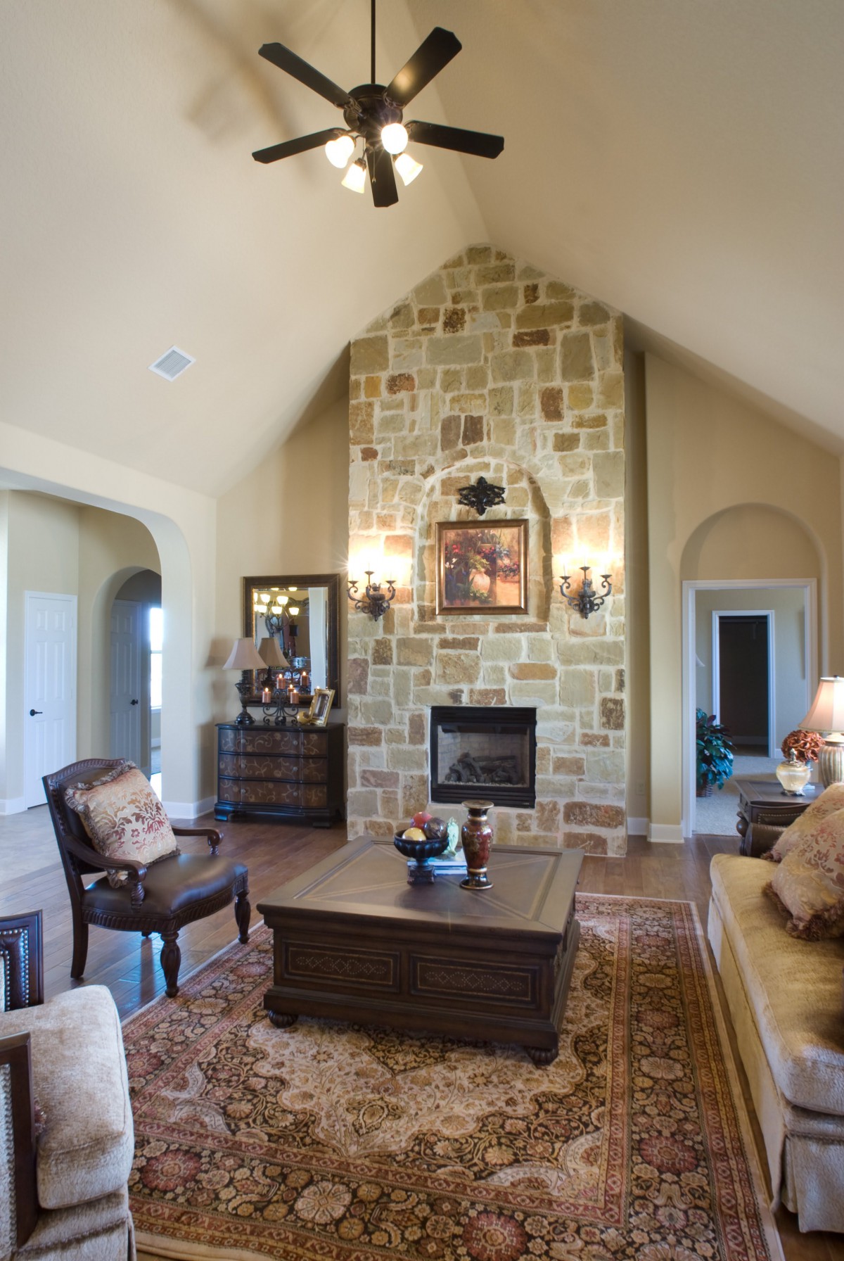 Cozy living room with a stone fireplace and elegant decor.