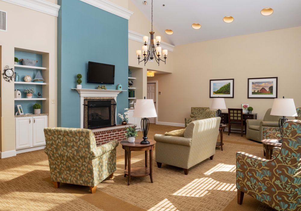 A cozy living room with comfortable seating, a fireplace, and a television.