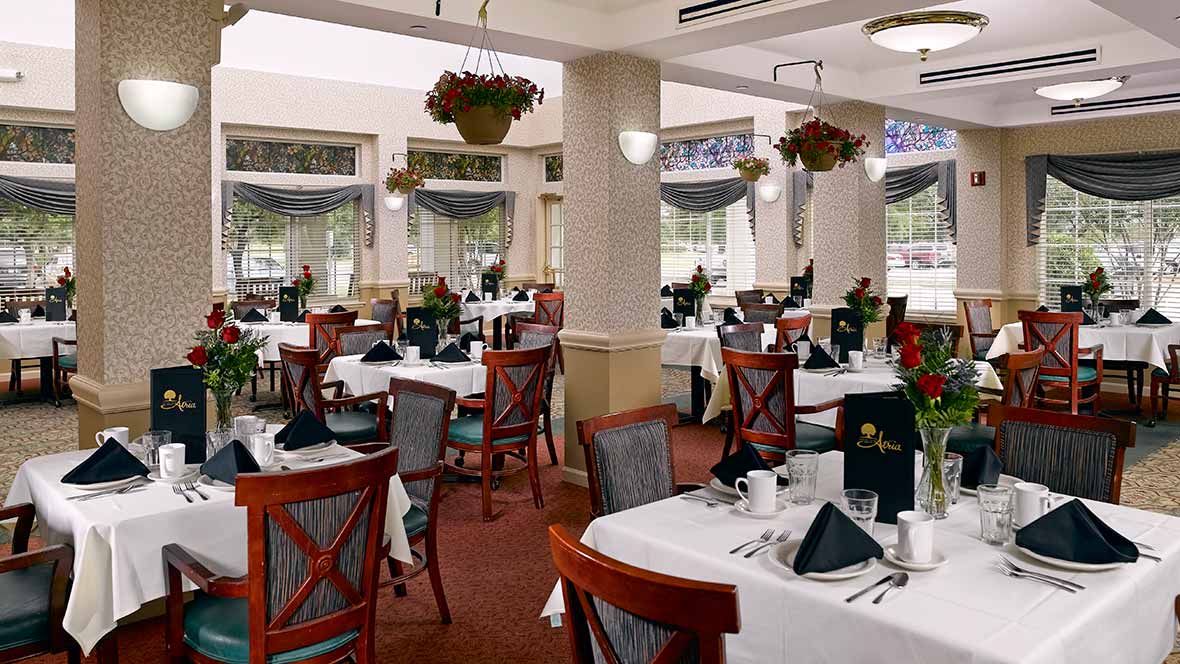 A well-arranged restaurant dining area with neatly set tables and chairs.