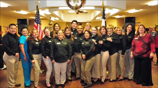 A team of dedicated employees posing together in a professional environment.