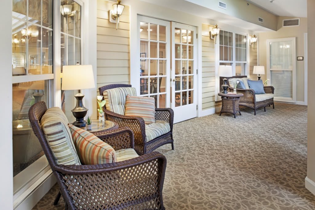 A cozy patio area with wicker furniture and warm lighting.