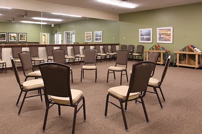 An empty meeting room with chairs arranged in a circle.