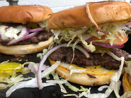 Delicious burgers stacked with fresh ingredients, ready to be enjoyed.