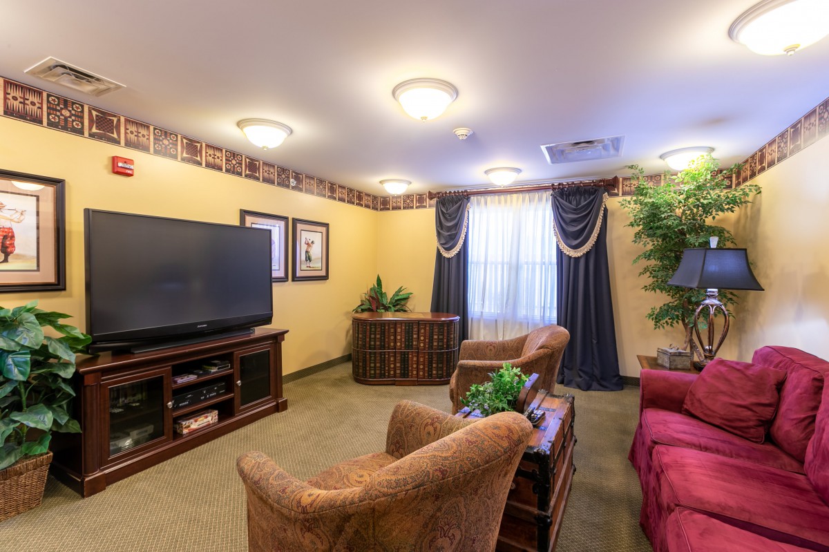 Cozy living room with a large TV and comfortable seating.