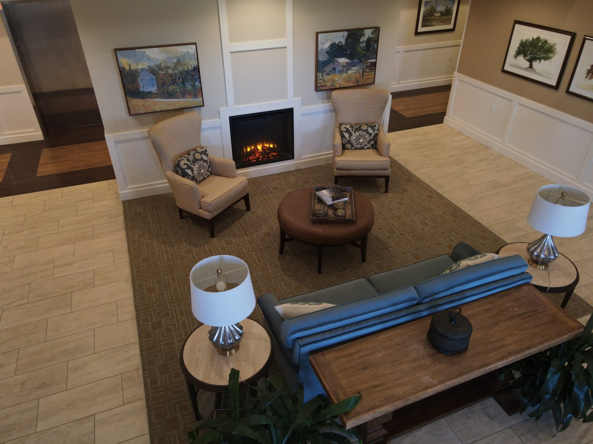 A cozy living room with comfortable seating arranged around a fireplace.