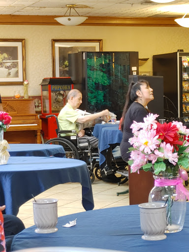 Residents enjoying time in the activity room of a senior living facility.