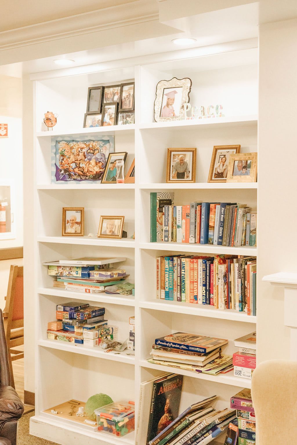 A cozy bookshelf adorned with books and photo frames, enhancing the home decor.
