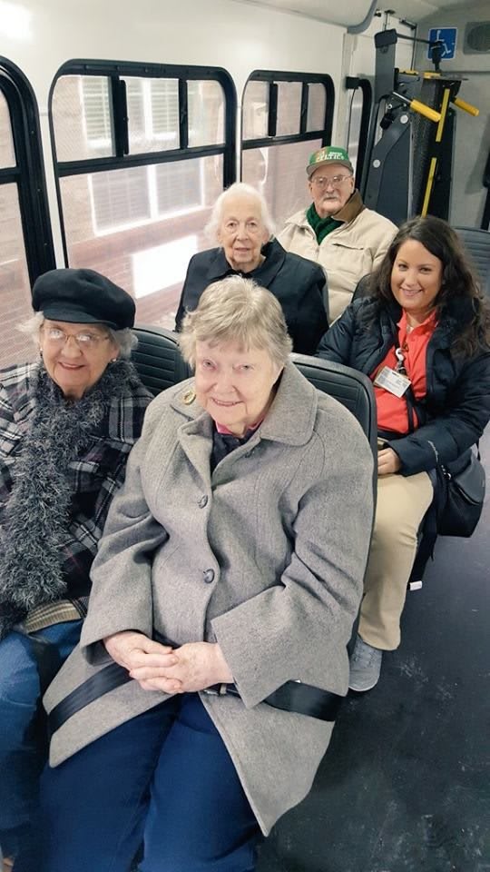 A group of seniors enjoying a bus ride together.