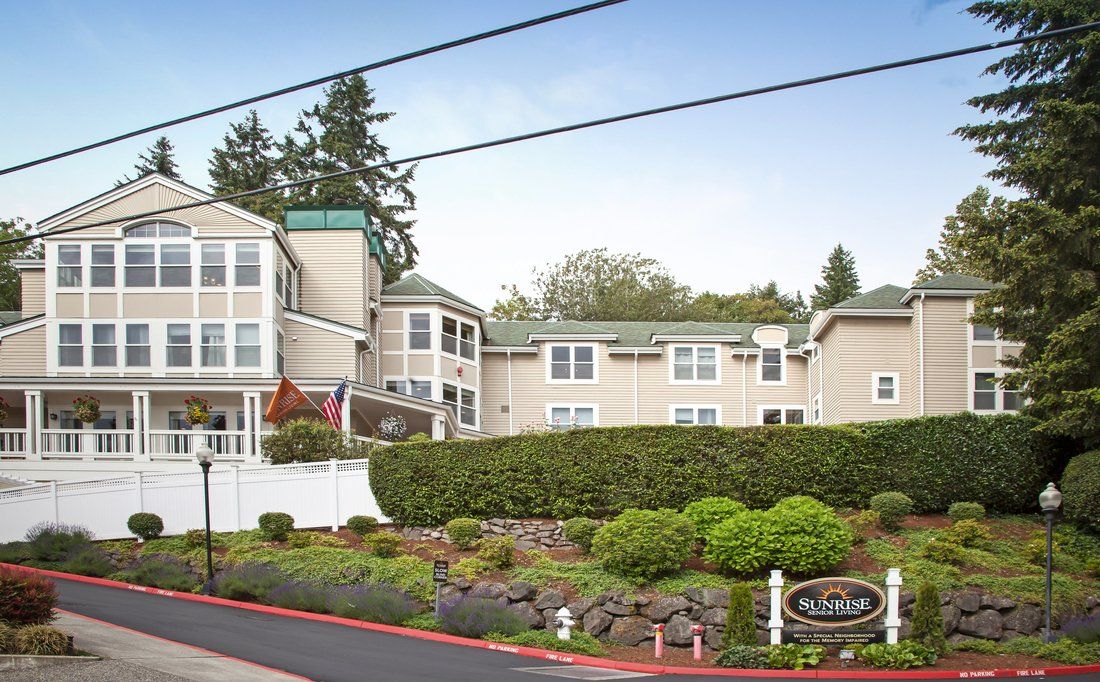 A residential building surrounded by lush greenery and manicured landscaping.