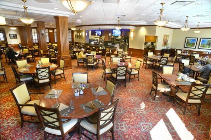 Spacious dining area with elegantly arranged tables and chairs in a restaurant.