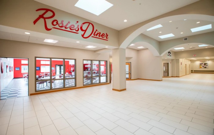 An empty mall hallway featuring Rosie's Diner with large glass windows and a prominent sign.