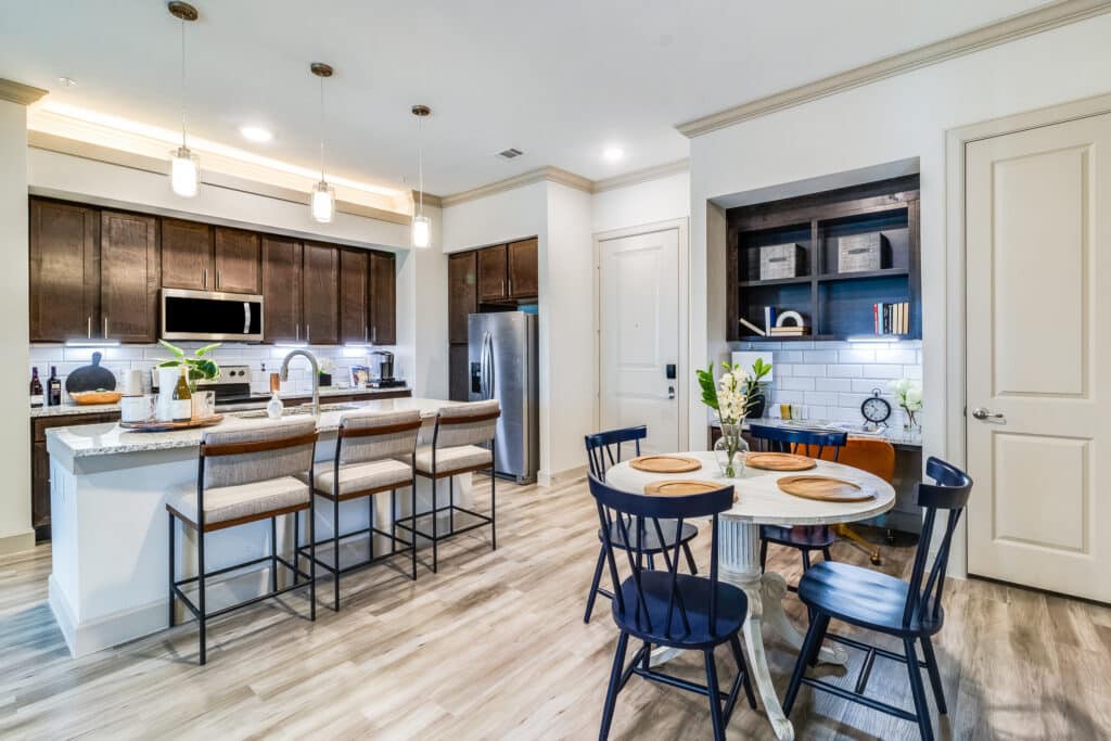 A modern open-concept kitchen and dining area with sleek furnishings and minimalist decor.