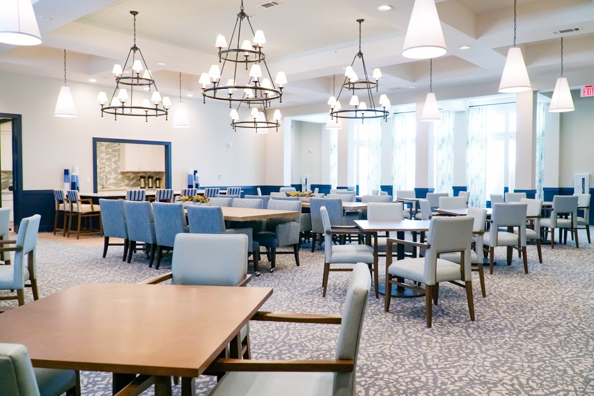 A spacious and elegantly designed dining area with modern furniture and lighting.