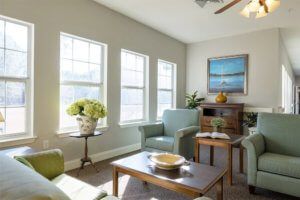 A bright and modern living room with comfortable seating and large windows.