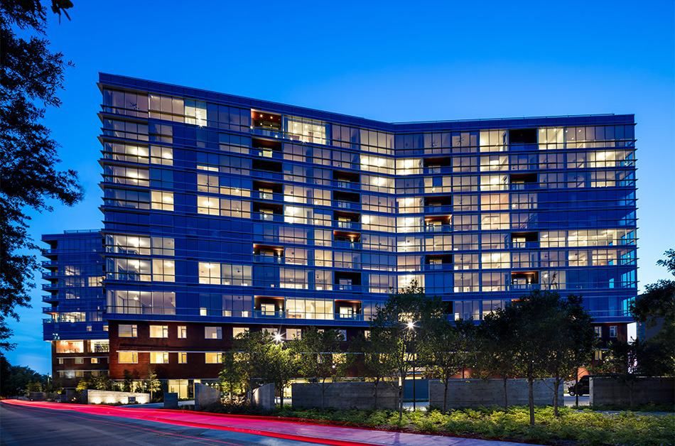 A modern building with illuminated windows at night.
