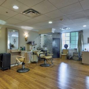 A modern and stylish hair salon interior with chairs and mirrors.