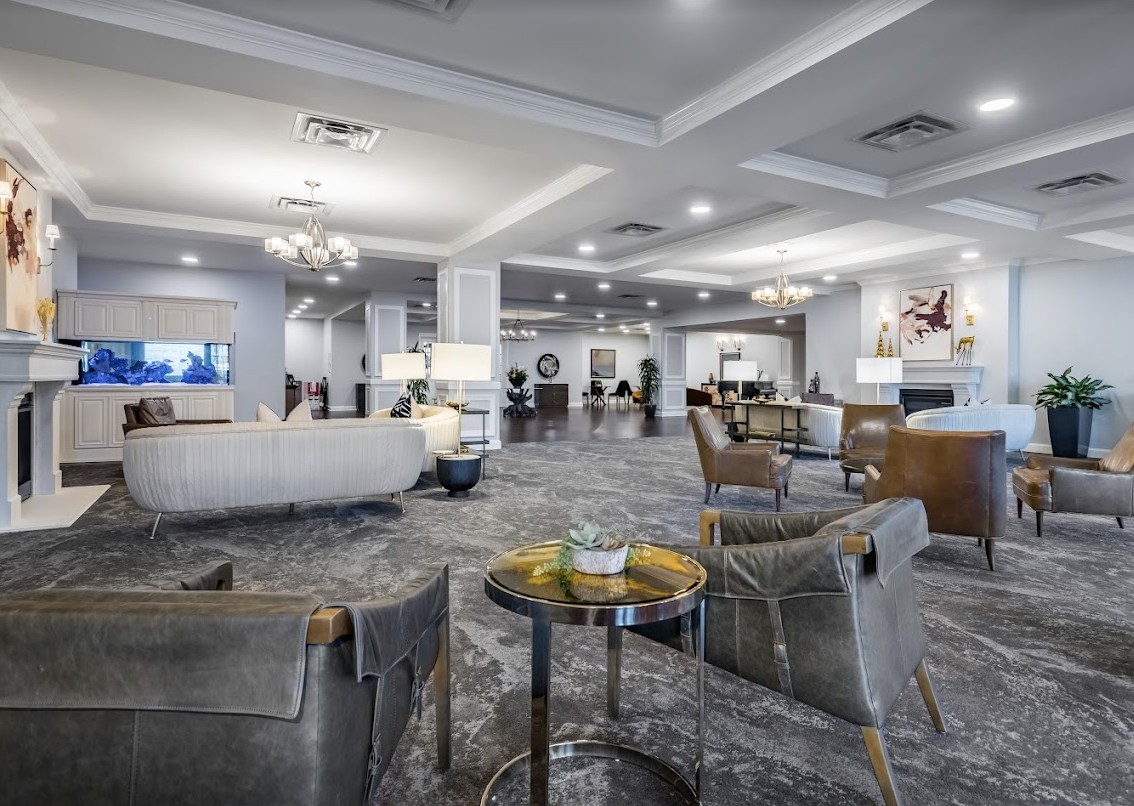 A spacious and elegantly designed hotel lobby with modern furniture and ambient lighting.